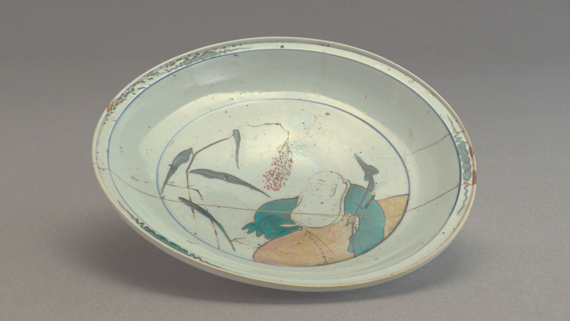 Shallow Kokutani (Old Kutani) bowl with design of Hotei (Budai)